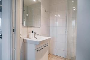 a white bathroom with a sink and a shower at Edsviken Hotell in Stockholm +59 photos