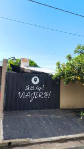 a black fence with white graffiti on it at Hostel y Motoposada Sudaka in Garupá