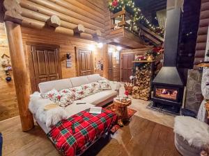 a living room with a white couch and a fireplace at House Villa Ursus in Gerovo +44 photos