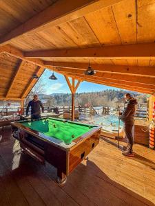 a group of men playing pool on a deck at House Villa Ursus in Gerovo