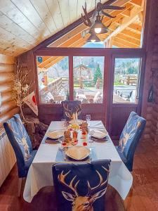 a dining room with a table and chairs and a window at House Villa Ursus in Gerovo