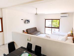 a living room with a couch and a table at Hotel Céntrico Tulum in Tulum