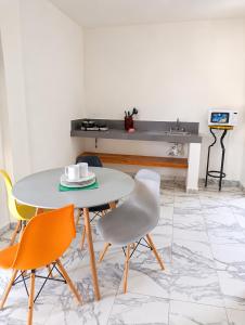 a table and chairs in a room with a counter at Hotel Céntrico Tulum in Tulum