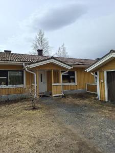 a yellow house with a driveway in front of it at Huoneisto Rivimerta, Siikajoki in Siikajoki