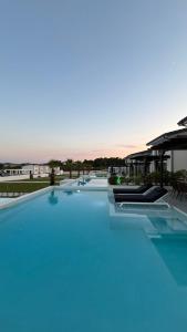 a large swimming pool with blue water at ZOSANA Villa in Kallithea Halkidikis