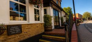 a building with a sign in front of it at The Crouch Oak in Addlestone
