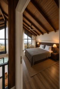 a bedroom with a large bed and large windows at Voger Sapanca Lake View in Sapanca +101 photos