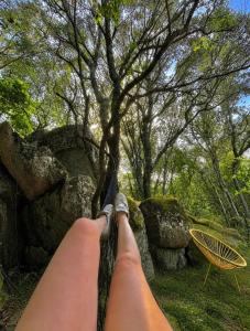 a person laying on a hammock under a tree at Bulle d'Alma - Bio climatique in Sotta