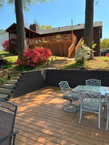 a patio with a table and chairs on a deck at Lakefront Serenity in Marietta