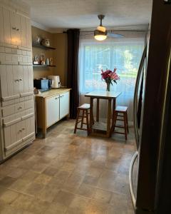 a kitchen with a table with a vase of flowers on it at Lakefront Serenity in Marietta
