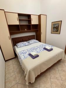 a bedroom with a bed with two towels on it at Winery Bačić in Blato
