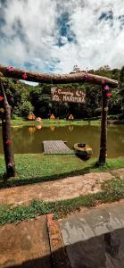 a park with a lake and a sign in the background at Apartamento no Camping Mairipora in Mairiporã +3 photos