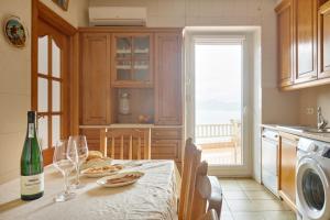 a kitchen with a table with a bottle of wine at Kai in Getaria +21 photos