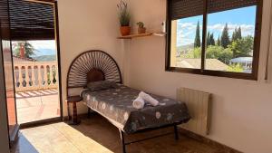 a room with a bed in a room with a window at Casa El Jazmín in Alfacar +20 photos