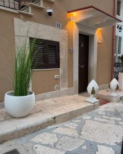 a front door of a house with a plant at Casa La Grotta in Bitonto