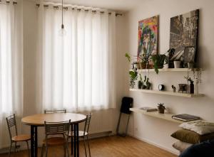 a dining room with a table and chairs and a window at Central Hub in Brussels