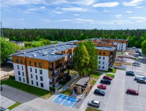 an aerial view of a parking lot with buildings at Apartament Pod Modrzewiem in Augustów