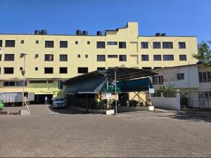a large building with a tent in front of it at Lorenas Tuffoam mall Apartment in Kisumu