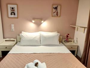 a bedroom with a bed with towels on it at Apartments Papadioti in Pefki