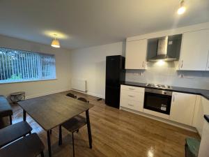 a kitchen with a table and a dining room at London Heathrow Hayes Escape in South Ruislip Station +27 photos
