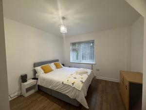 a bedroom with a bed and a window at London Heathrow Hayes Escape in South Ruislip Station