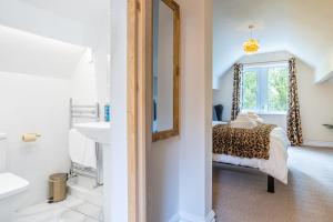 a bathroom with a bed and a sink and a mirror at Lindores Bed & Breakfast in Todmorden +31 photos
