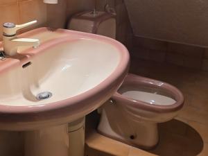 a bathroom with a sink and a toilet at KiteBay Villa in Rákhai