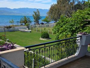 a balcony with a view of the water at KiteBay Villa in Rákhai