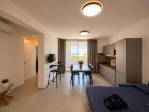 a living room with a kitchen and a dining room at Sea & Pool Apartment in Casa Santa