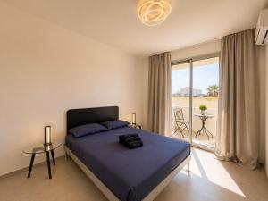 a bedroom with a large bed and a balcony at Sea & Pool Apartment in Casa Santa +25 photos