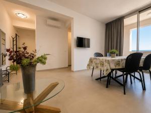 a living room with a dining room table and chairs at Sea & Pool Apartment in Casa Santa