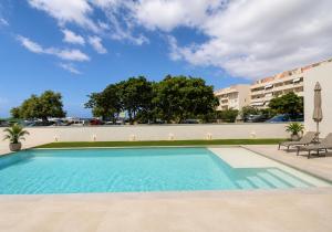 a swimming pool in front of a building at Sea & Pool Apartment in Casa Santa