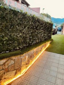 a stone wall with a light on a sidewalk at Live Home Rooms in Villasimius