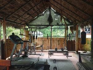 a gym with a treadmill and weights in a building at Grand Selva Lodge & Tours in Tena