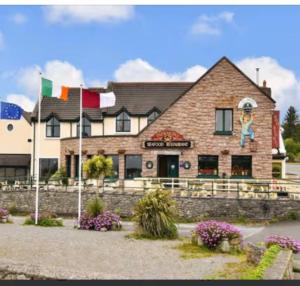 a building with flags in front of it at The Blue Lodge in Galway