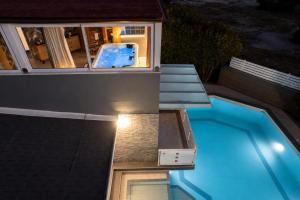 a view of a swimming pool at night at Moresca Luxury Private Villa & Spa in Castellammare del Golfo