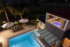 a house with a swimming pool at night at Moresca Luxury Private Villa & Spa in Castellammare del Golfo