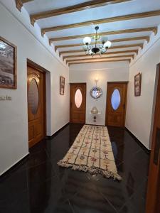a hallway of a house with a rug on the floor at Dar Joud Kaouki in Sidi Kaouki