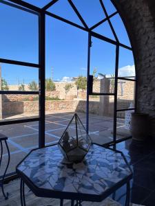 a glass table with a vase on top of it at Dar Joud Kaouki in Sidi Kaouki