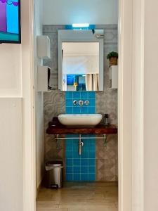 a bathroom with a sink and a mirror at Live Home Rooms in Villasimius