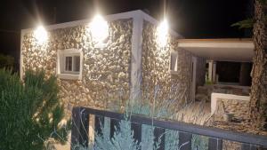 a stone house with lights on the side of it at Aelia House Kefalos - Cozy & Quiet in Kos +8 photos