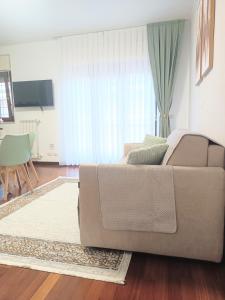 a living room with a couch and a table at Cristine's House in Marino