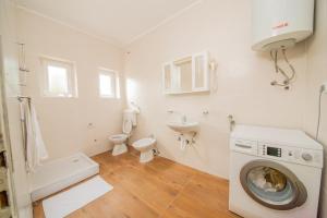 a bathroom with a washing machine and a sink at Hotel Riviera in Starigrad +19 photos