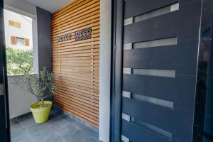 a garage door with a plant in a pot next to it at Apartmani Pocco Locco in Biograd na Moru