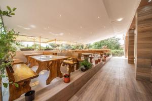 an empty restaurant with wooden tables and benches at Hotel Riviera in Starigrad