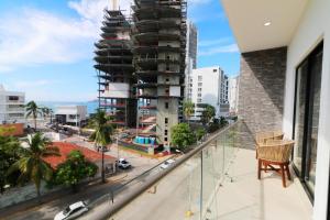 a balcony with a view of a city at Beautiful apartment just 1 block from the beach. in Mazatlán