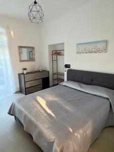 a bedroom with a large bed and a mirror at Poggio sul Mare in Alberese