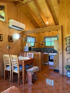 a kitchen with a table and chairs in a room at Parcela Peumayen casa 2 in Pucura