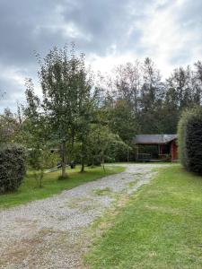 a gravel road in front of a house at Parcela Peumayen casa 2 in Pucura
