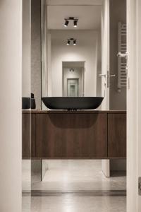 a bathroom with a black tub in front of a mirror at The Loft, An Architects Dream in Târgu-Mureş +15 photos